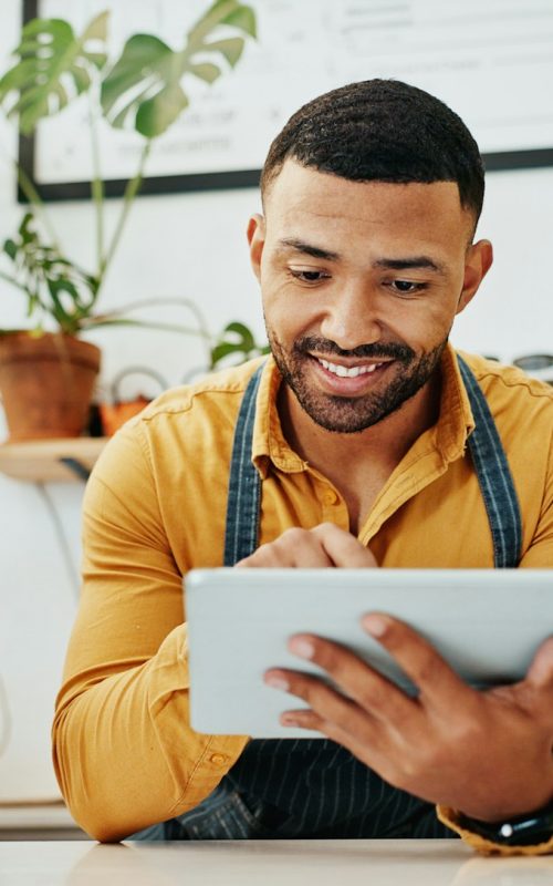 Waiter, tablet and smile in cafe for hospitality, website and service with virtual menu, stock and